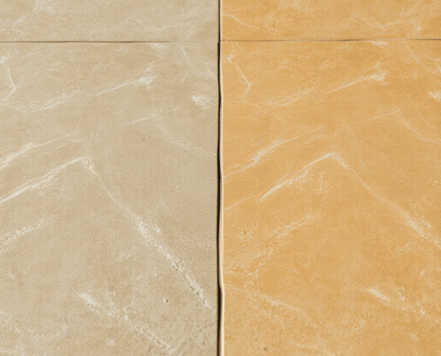 Close-up of a natural stone floor showing a smooth transition from dull, worn texture to polished, shiny surface under soft natural light.