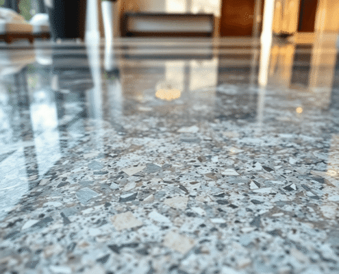 Close-up of a polished granite floor with natural patterns and soft light reflections, highlighting its smooth, glossy surface in a modern home int...