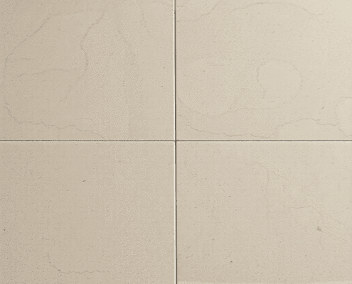 Close-up of elegant travertine floor tiles with natural earth tones, unique patterns, and varied polished and honed textures under soft lighting.