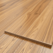 Close-up of glossy luxury vinyl flooring with realistic wood grain texture and subtle reflections, highlighting durability and premium quality.