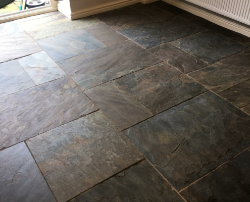Slate floor before cleaning, stripping and satin sealing in Baddington, Nantwich