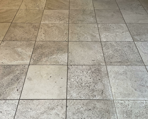 Travertine floor before cleaning, filling and sealing in Clutton, Nr Broxton, Cheshire