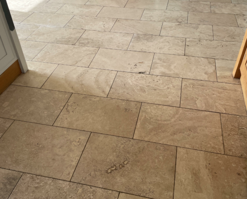Travertine floor before cleaning, hole filling, honing and sealing in Audlem, Cheshire