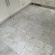 Travertine kitchen floor after cleaning and sealing in Macclesfield, Cheshire